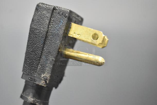Close-up of a plug from the 2018 True T-35-HC Commercial Cooler. 115 volts, visible detail on the prongs.