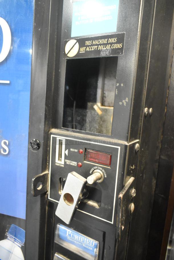 Royal RVCDE-768-10 vending machine, coin-operated, shows wear, 115 volts, 1 phase, does not accept dollar coins.