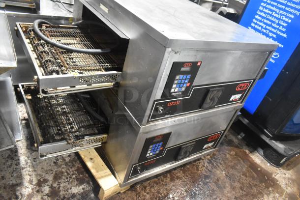 Two 2021 Middleby Marshall CTX DZ33I stainless steel conveyor pizza ovens, electric powered, on commercial casters.