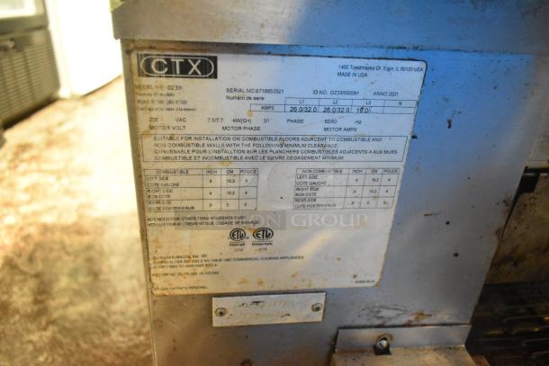 Middleby Marshall CTX DZ33I tag indicating model, serial number, 208V, 3/1 phase, made in USA, commercial use specs.