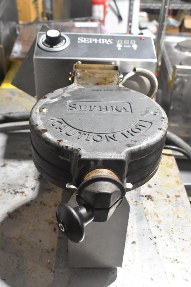 Sephra SEMANWB110V-01 countertop waffle maker in used condition, 110-120 volts, visible heat caution marking.