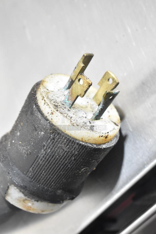 Close-up of a power plug for a Middleby Marshall CTX DZ33T commercial conveyor pizza oven, showing slight wear.