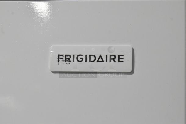 "Frigidaire FFTR2045VWD cooler with freezer, brand new with scratches. Visible Frigidaire logo on white surface."