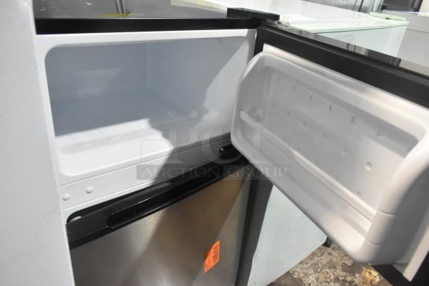 Vissani MDCM31SS5 mini cooler with freezer, 115 volts, open door view showing interior shelves and freezer compartment.