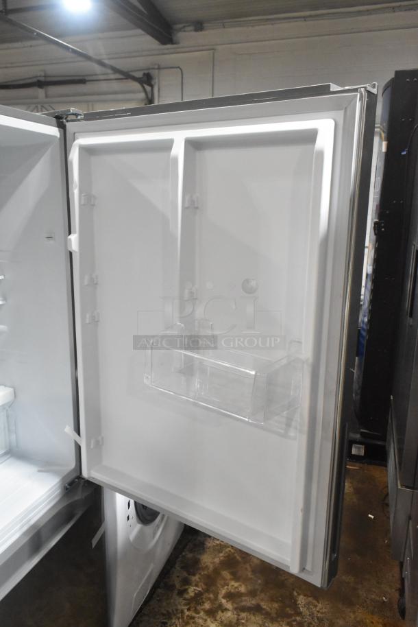Reach-in cooler with freezer drawer, 115 volts, 1 phase. Features a clear bin on the door. Excellent condition.