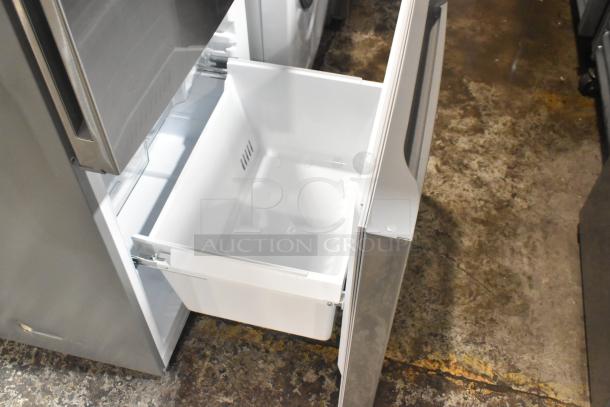 Reach-in cooler with freezer drawer open, stainless steel finish, 115 volts, 1 phase, in excellent condition.