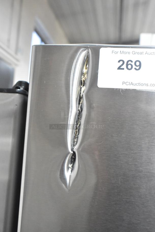 Vissani Reach In Cooler with visible dent on the side, 115 volts, 1 phase. Auction label "PCI Auctions 269" attached.