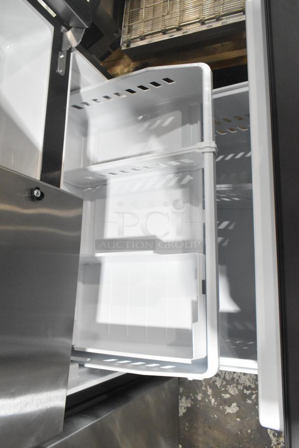 GE GNE27JYMYFFS reach-in cooler with freezer drawer, 115V, 1-phase. Stainless steel exterior, adjustable shelves, excellent condition.