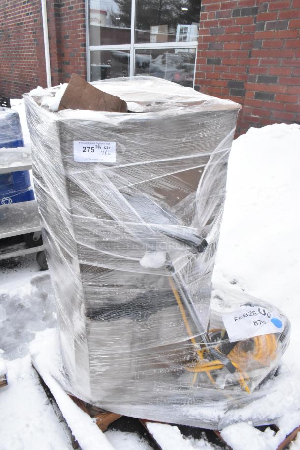 Pallet with 2 new, scratch and dent items including a floor cleaning machine, wrapped in plastic, labels visible showing auction details.