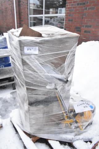 Pallet with 2 new, scratch and dent items including a floor cleaning machine, wrapped in plastic, labels visible showing auction details.