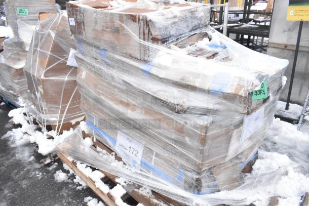 Plastic-wrapped pallet containing nine scratch and dent items, featuring a squeegee, posts, and strip warmer, in snowy outdoor setting.
