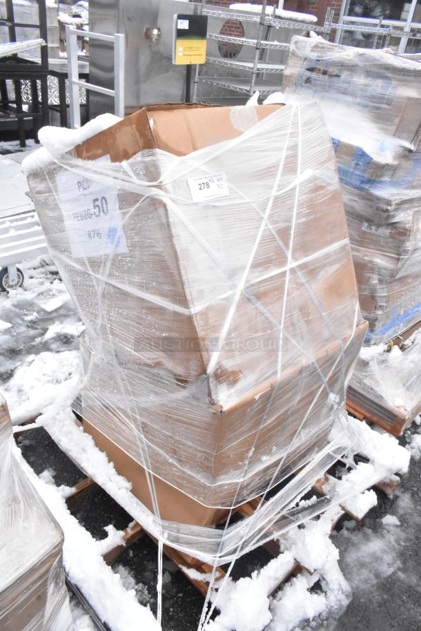 Pallets of brand new, scratch and dent items, including ice bins, wrapped in plastic, outdoors in snowy setting.