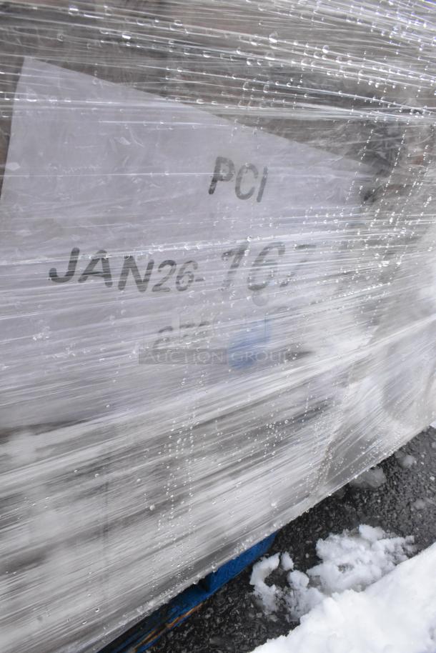 Plastic-wrapped pallet labeled "PCI JAN26." Contains five scratch and dent items, including a bi-folding table and side chair.