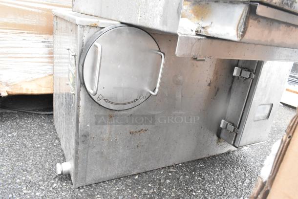 Environmental GGX-25 grease trap, 50 lb. capacity, stainless steel, visible wear, exterior handle, side outlet.