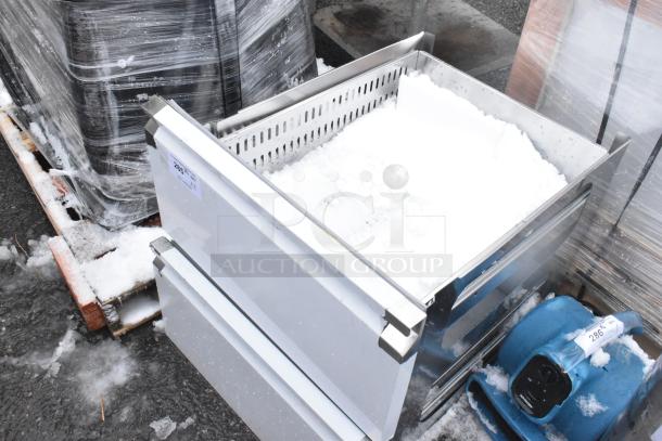 New metal drawers with slight damage, wrapped and stacked outdoors. Marked "286" for auction. Unused condition.