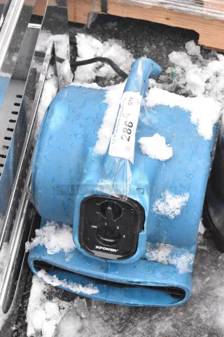 Xpower P-230AT air mover, blue, 120 volts, 1 phase, visible wear with some snow on surface, labeled with auction tag "286".