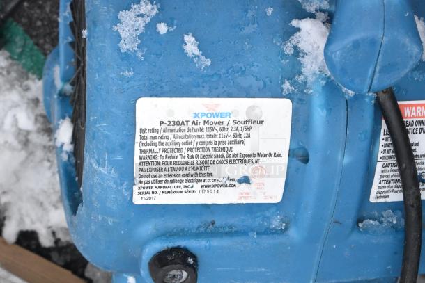 Xpower P-230AT Air Mover, blue, 120V, 1 phase. Label shows model, specs, thermally protected. Visible wear and snow.