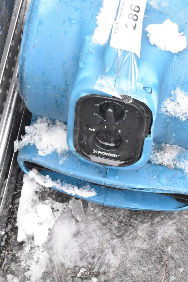 Xpower P-230AT Air Mover, blue, 120V, 1 phase, used, with visible snow and ice. Control panel has settings 1-3.