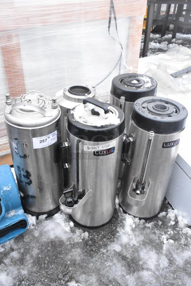 Five Fetco Luxus beverage dispensers, including TPD-15 model, stainless steel, used condition, visible usage labels.