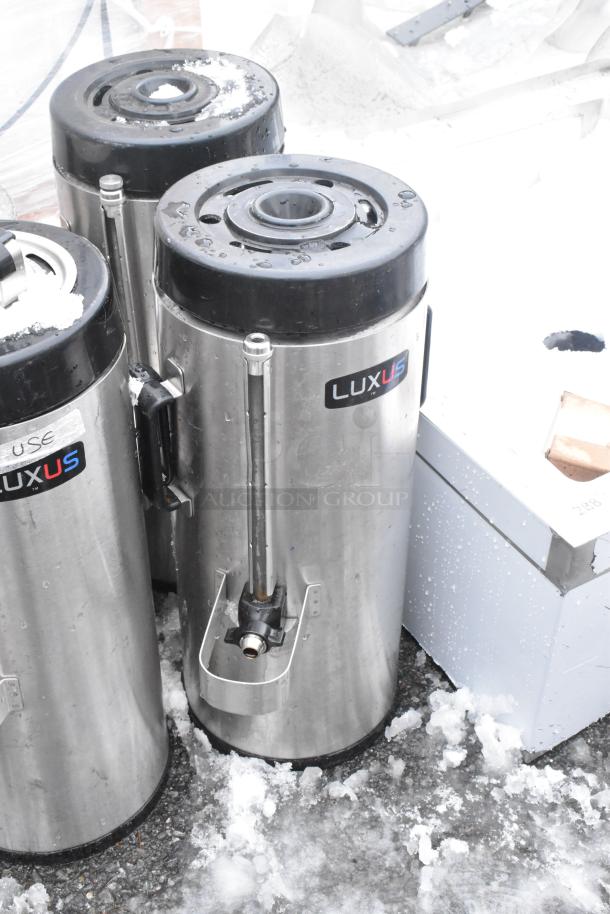 5 Fetco Luxus beverage dispensers, including TPD-15 model, stainless steel, visible Luxus branding, fair condition.