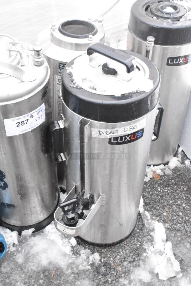 Set of 5 Fetco Luxus beverage dispensers, including TPD-15 model. Stainless steel, pre-owned, visible labels and snow.