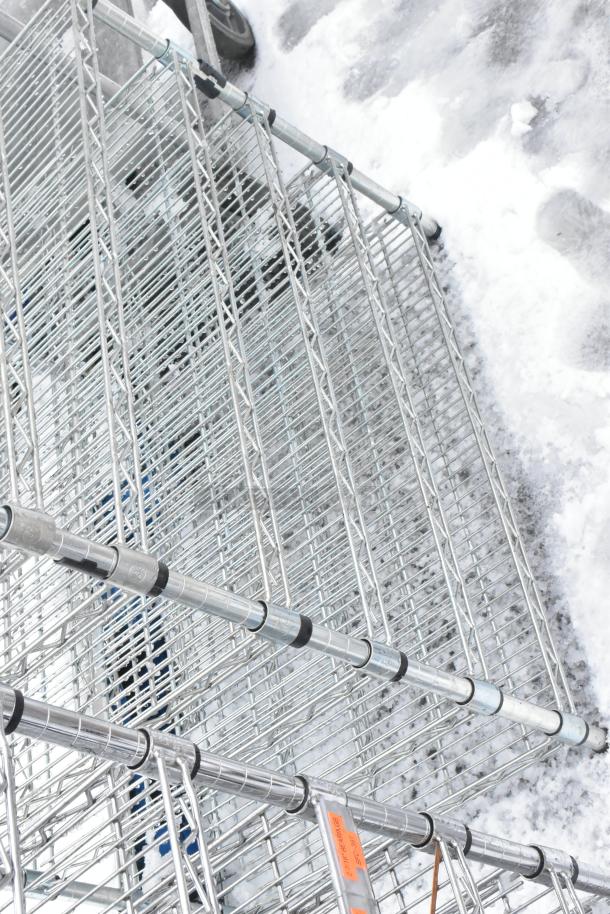 Chrome finish 9-tier wire shelving unit in good condition, with visible structural elements, requires buyer dismantling.