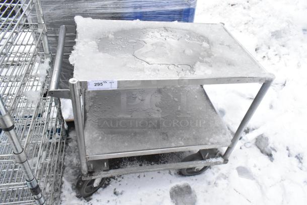 Two-tier metal cart with ice, on commercial casters. Label reads "295 QTY." Used condition, sturdy construction.