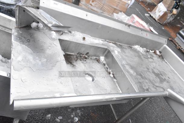 Commercial right side dirty dish table with drain, stainless steel, visible wear and surface rust, outdoor setting.