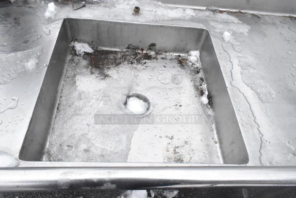 Stainless steel commercial dish table with sink, worn condition, showing water stains and ice. For right-side dirty dishes.