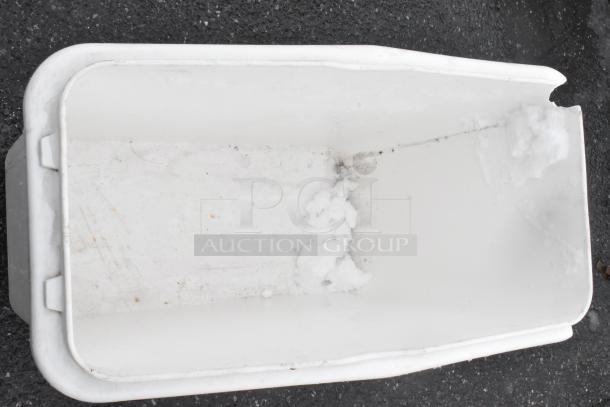 White poly ingredient bin on commercial casters, shows signs of use with residue inside, suitable for food storage or transport.