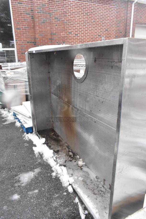 7.5' commercial steam hood, stainless steel, used condition with visible rust and stains, round vent cutout, no visible labels.