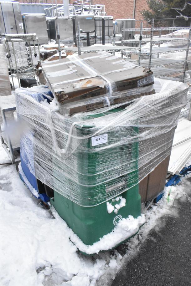 Stacked items including a wrapped green poly trash bin and 460EG2436 Regency 24"x36" NSF green epoxy wire shelf. Snow visible.