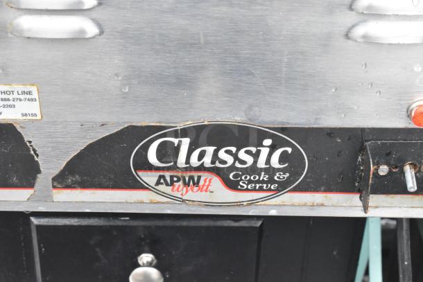 APW Wyott CW-2A Countertop Food Warmer with Classic Cook & Serve label. 120 Volts, 1 Phase, visible wear on the label.