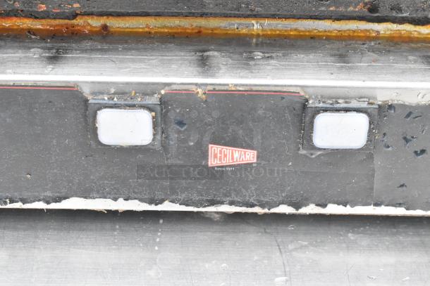 Cecilware Countertop Double Panini Press with visible wear. Features dual heating plates. Cecilware logo centered.