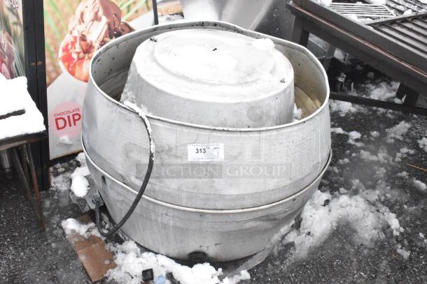 Mushroom rooftop exhaust fan, metal finish, visible wear, placed on a snowy surface. Auction tag 313 attached.