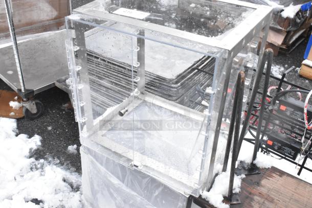 Two clear poly countertop cookie merchandisers, good condition, visible locking mechanism, ideal for displaying baked goods.