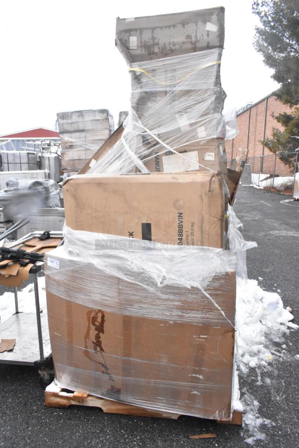 Shrink-wrapped pallet with assorted scratch and dent items, including shelves and tabletop. Visible cardboard boxes and plastic wrapping.
