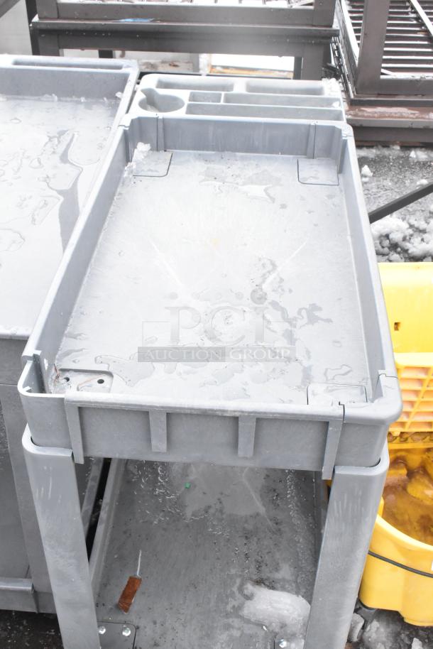 2 Poly 2 Tier Cart with commercial casters, durable plastic, wet surface, used condition, multi-compartment design.