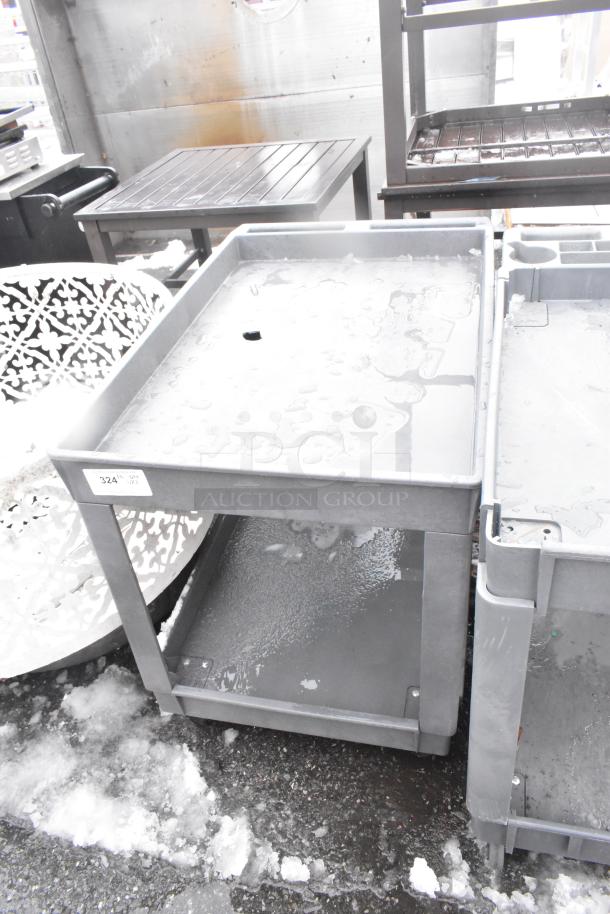 2-tier gray poly cart on commercial casters, shown in used condition, features a label with the number 324. Ideal for commercial use.