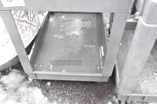 2-tier poly cart with commercial casters, visible wear and moisture, grey plastic, includes item tag "324."