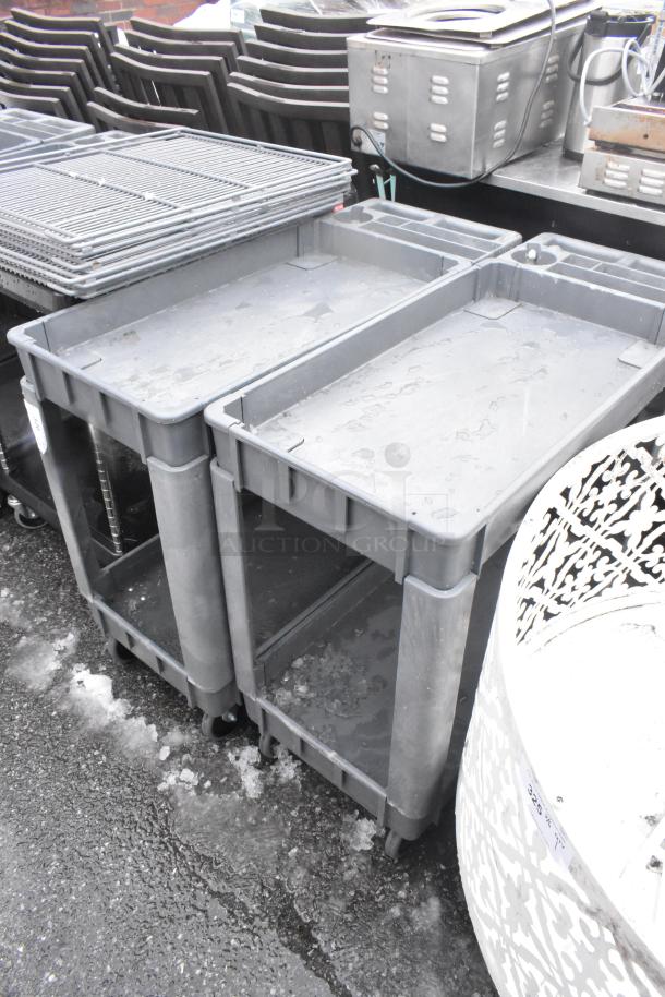 2 Poly 2 Tier Carts on Commercial Casters, gray, durable, ideal for industrial use. Stackable, showing minimal wear.