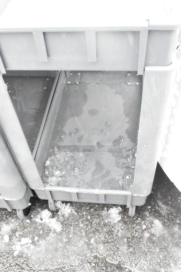 2-tier poly cart on commercial casters, used condition, visible moisture, sturdy structure, ideal for heavy-duty use.