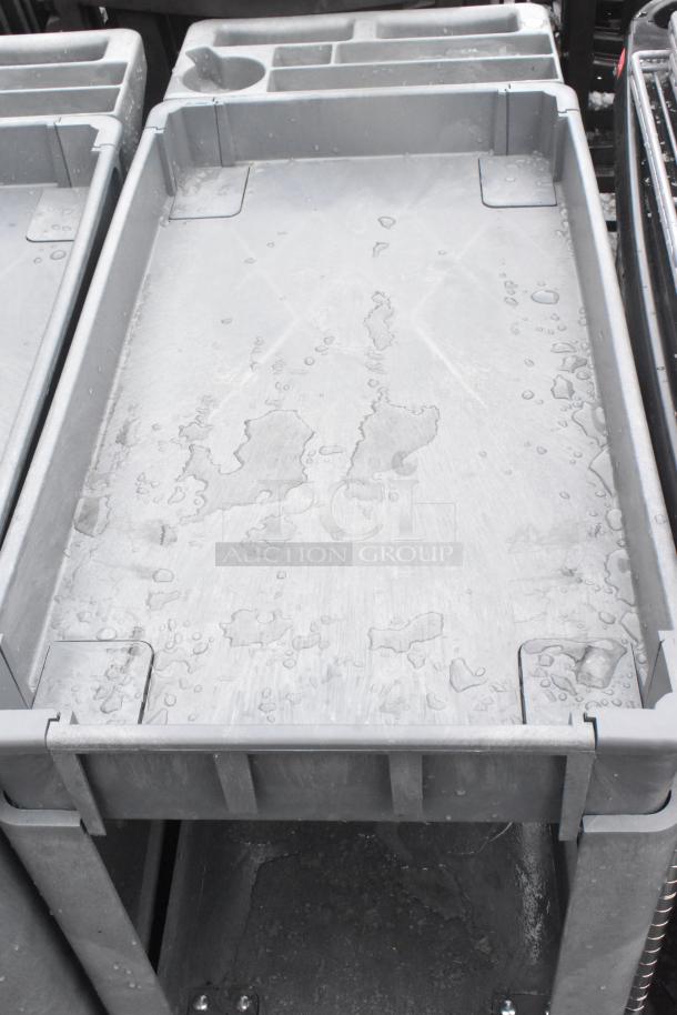 2 Poly 2-Tier Cart with commercial casters, gray, features raised edges and compartments, good condition.