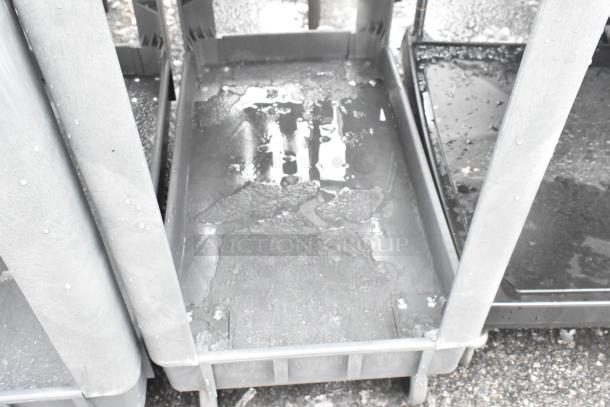 Two-tier poly cart with commercial casters in used condition, showing water on trays, suitable for multipurpose storage and transport.