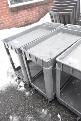 Two-tier poly cart on commercial casters, gray, used condition, label showing "326," durable for industrial use.