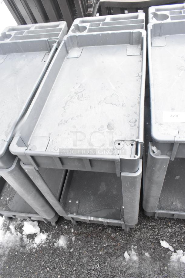 Gray 2-tier poly cart with commercial casters, showing surface wear. Auction tag "328" visible.