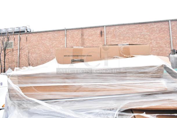 Clear plastic-wrapped pallet of 21 assorted new items, including Rubbermaid trash cans and Huhtamaki lids, in large cardboard boxes.