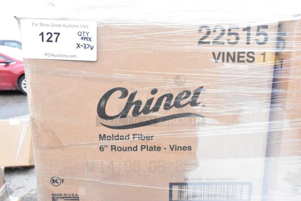 Boxes of Chinet 22515 Vines 6" Paper Plates, wrapped in plastic, labeled "Molded Fiber," "Made in USA," auction tag visible.