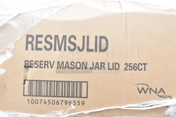 Cardboard box labeled "RESMSJLID RESERV MASON JAR LID 256CT" with barcode and WNA logo, wrapped in plastic.