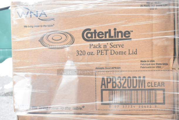 Boxes of WNA APB320DM Caterline Pack n Serve 320 oz PET Dome Lids, brand new, wrapped. Labels show product details.